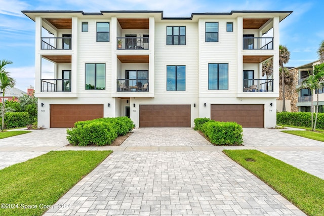 view of front facade with a garage and a balcony