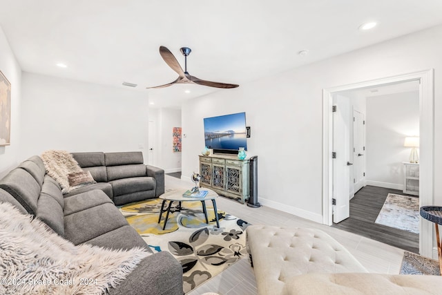 living room with ceiling fan and light wood-type flooring