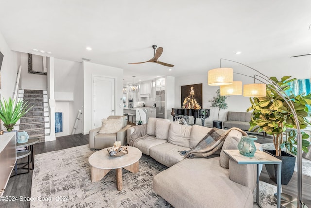 living room featuring light hardwood / wood-style flooring and ceiling fan