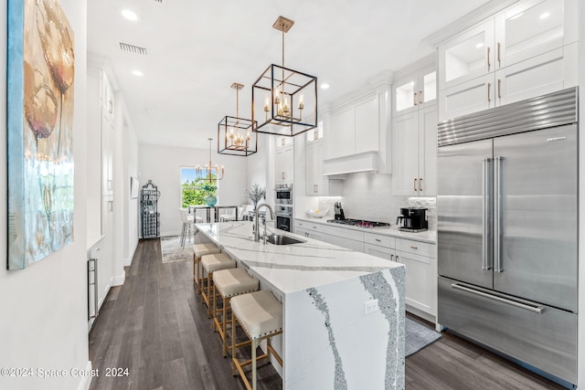 kitchen with stainless steel appliances, dark hardwood / wood-style floors, backsplash, and white cabinets