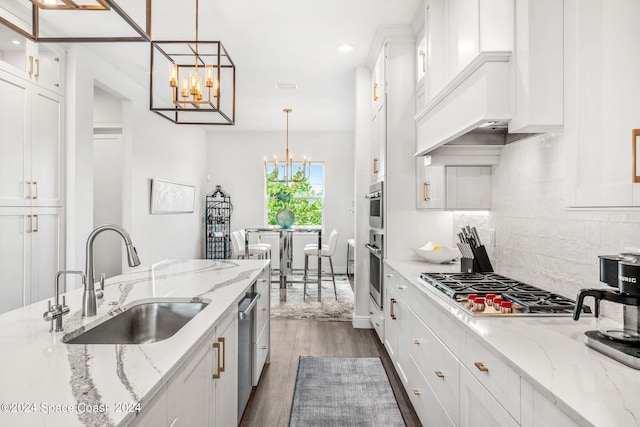 kitchen with pendant lighting, white cabinetry, sink, decorative backsplash, and dark wood-type flooring