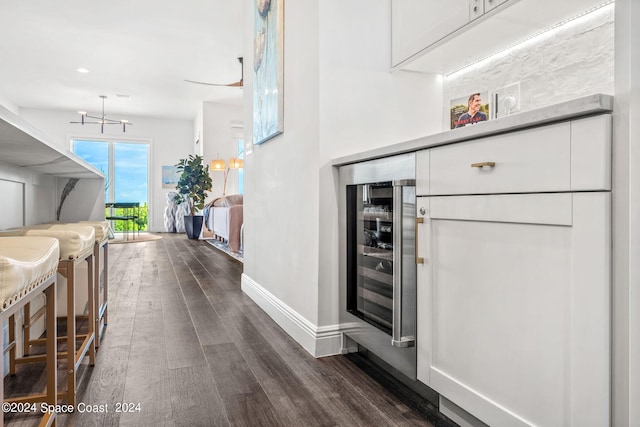 interior space featuring beverage cooler and dark wood-type flooring