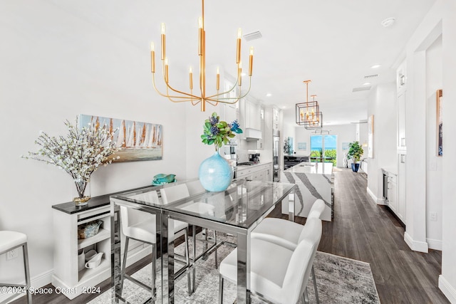 dining area with a chandelier and dark hardwood / wood-style flooring