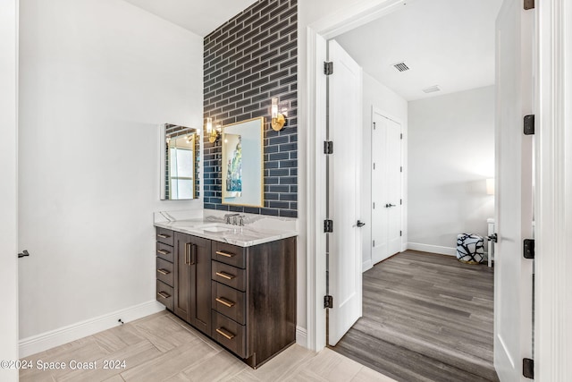 bathroom featuring vanity and hardwood / wood-style floors