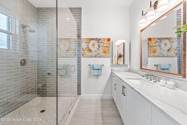 bathroom with vanity, walk in shower, and tile patterned flooring