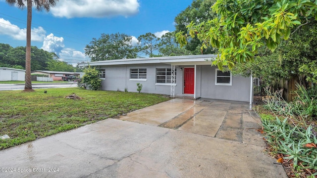 single story home with a front lawn and fence