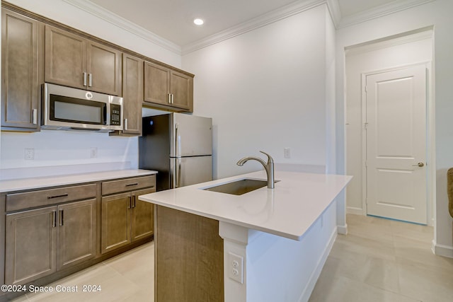 kitchen featuring light tile patterned flooring, appliances with stainless steel finishes, sink, and crown molding