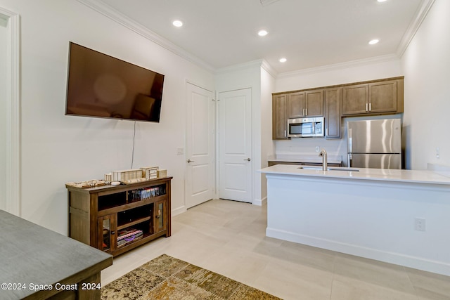 kitchen featuring sink, crown molding, light tile patterned flooring, and stainless steel appliances