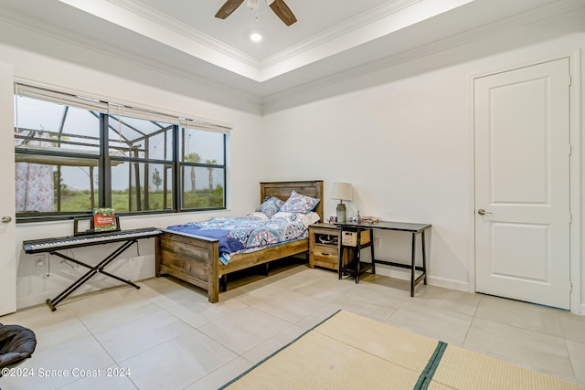 tiled bedroom with a tray ceiling, ceiling fan, and ornamental molding