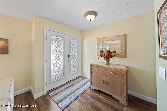 entryway featuring french doors, a textured ceiling, and dark hardwood / wood-style floors