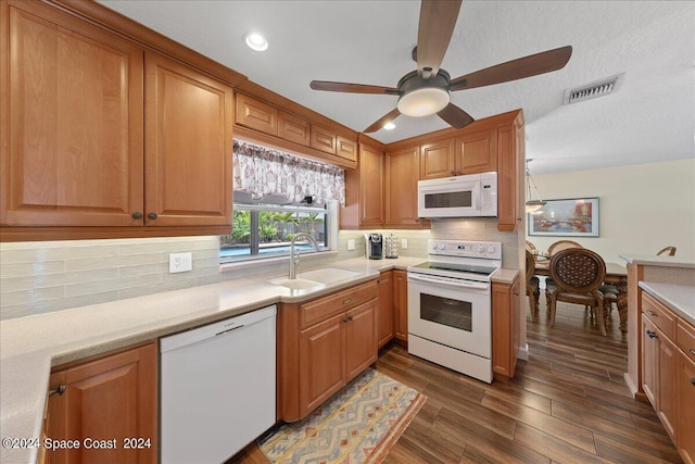 kitchen with decorative backsplash, white appliances, ceiling fan, sink, and dark hardwood / wood-style floors