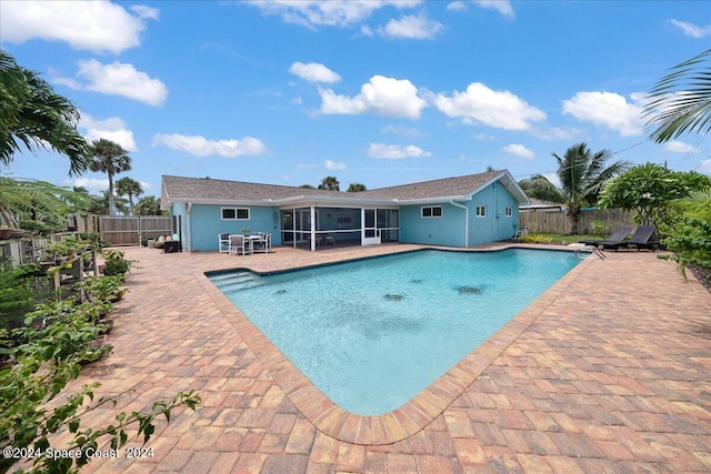 view of pool featuring a patio area and a sunroom