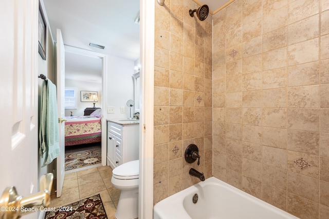 full bathroom with vanity, toilet, tile patterned flooring, and tiled shower / bath