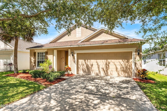 view of front of home featuring a garage and a front lawn