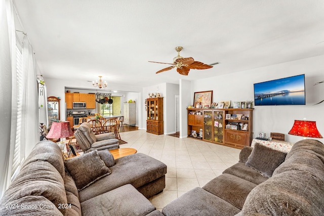 living room with ceiling fan with notable chandelier and light tile patterned flooring