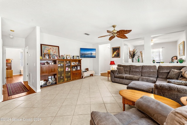 living room featuring ceiling fan and light tile patterned floors