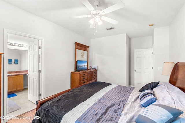 bedroom featuring ensuite bath and ceiling fan