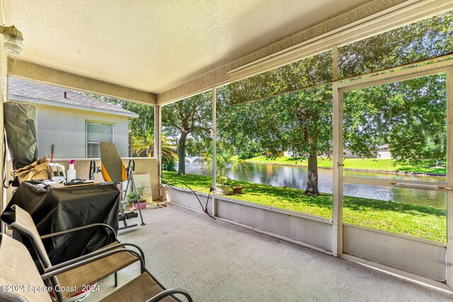 sunroom / solarium with a water view