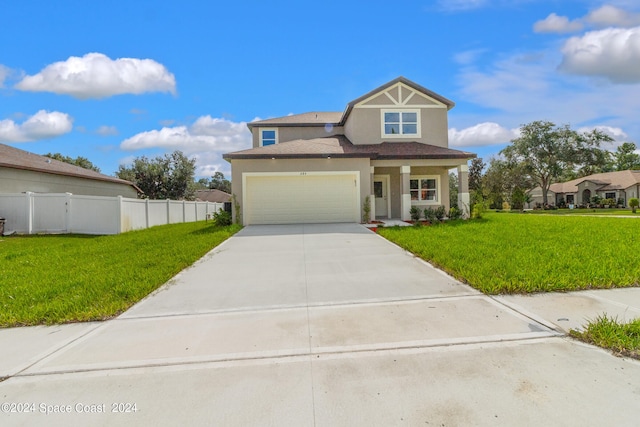 view of front facade with a front yard and a garage