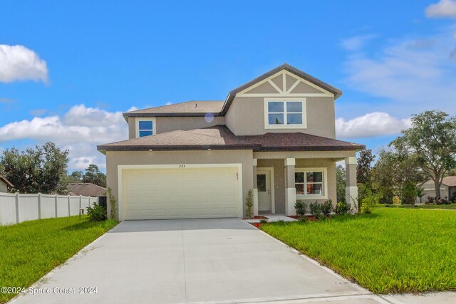 view of front of home featuring a garage and a front lawn