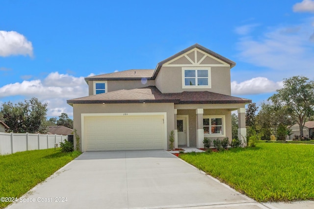 view of front of property featuring stucco siding, a front yard, fence, a garage, and driveway