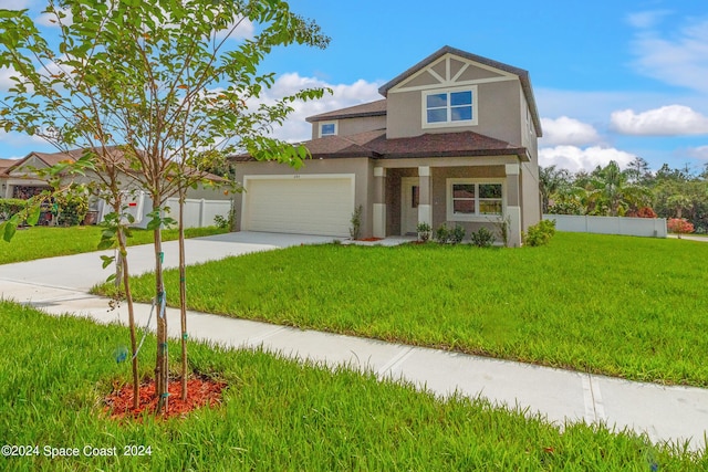 view of front of home featuring a garage, a front yard, fence, and stucco siding