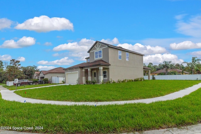 view of front of property featuring an attached garage, fence, a front lawn, and stucco siding