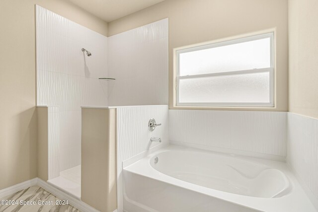 bathroom featuring plus walk in shower