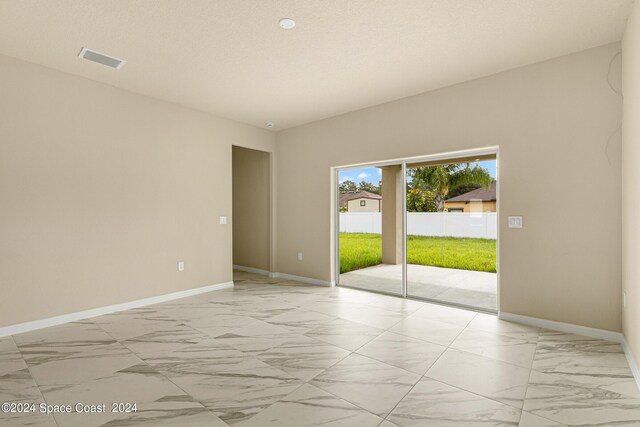 spare room with light tile patterned floors