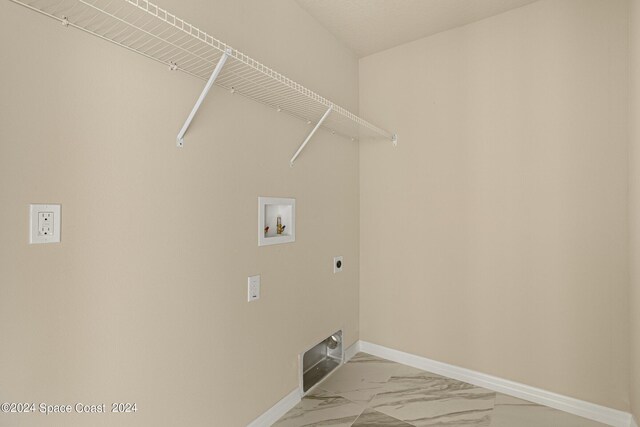 laundry area with washer hookup, electric dryer hookup, and light tile patterned floors