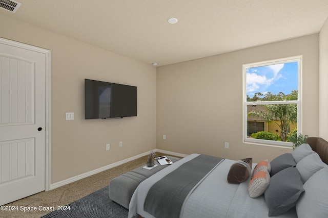 bedroom featuring carpet, visible vents, and baseboards