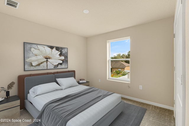 bedroom featuring carpet floors, baseboards, and visible vents