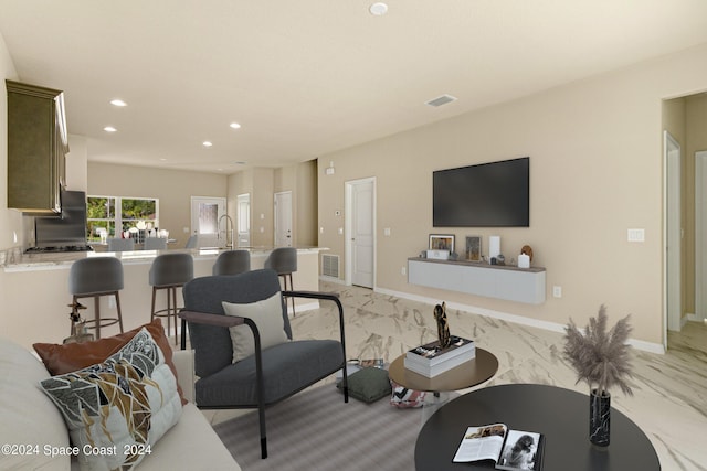 living room with baseboards, marble finish floor, visible vents, and recessed lighting