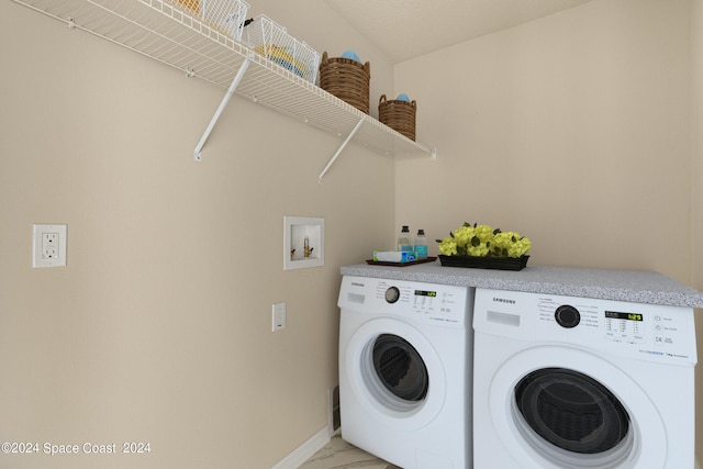 clothes washing area with washer and dryer