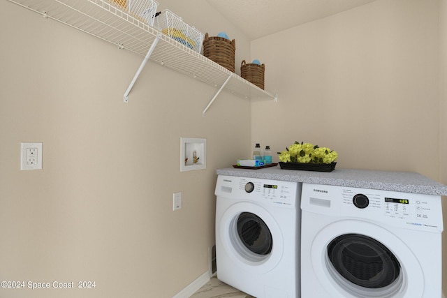 washroom featuring laundry area, washing machine and dryer, baseboards, and marble finish floor