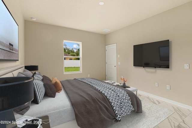 bedroom with marble finish floor and baseboards