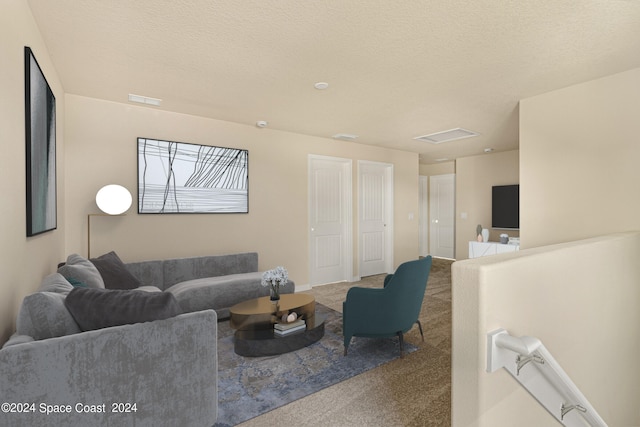 living room with a textured ceiling and carpet floors