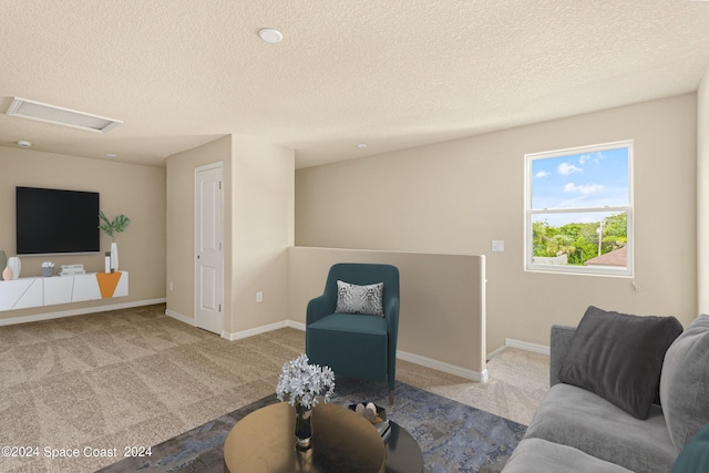 sitting room with carpet, baseboards, attic access, and an upstairs landing