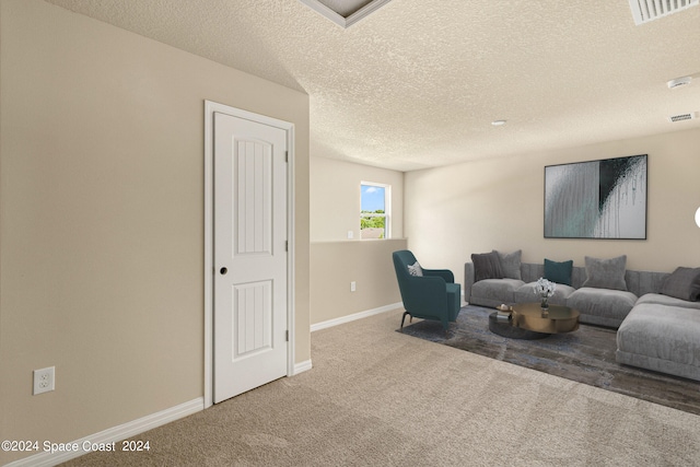 living room with a textured ceiling and carpet