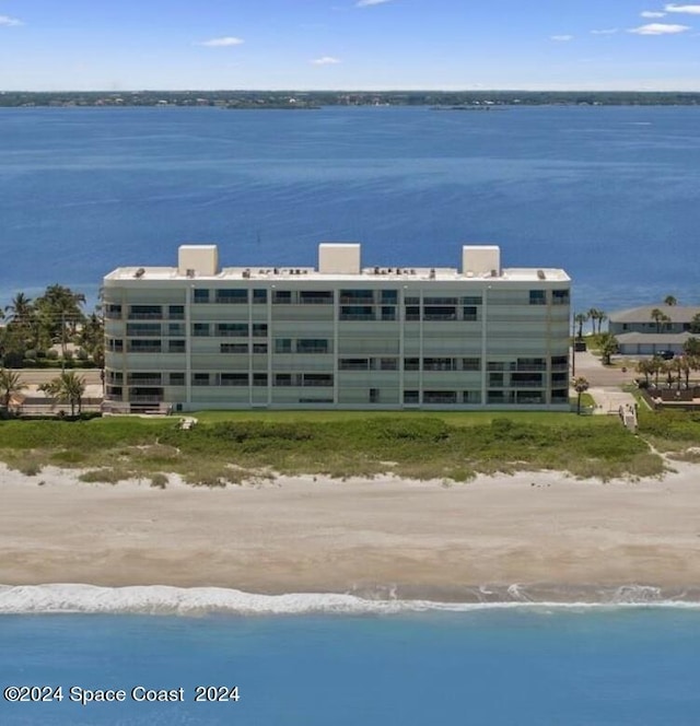 drone / aerial view with a water view and a view of the beach