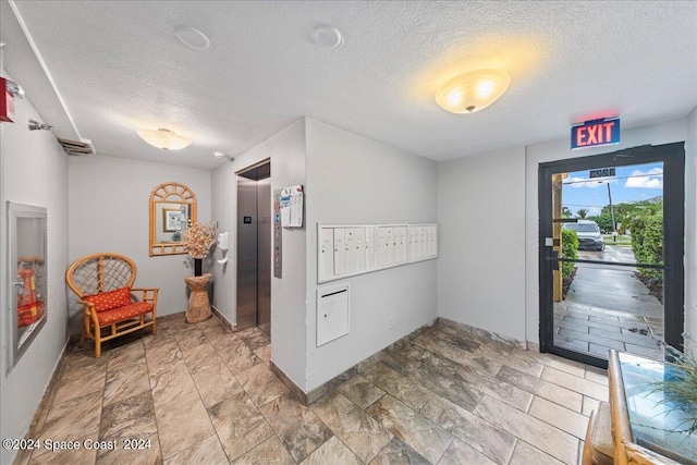 kitchen featuring a textured ceiling, elevator, and tile patterned floors