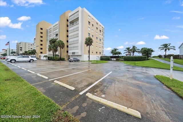 view of building exterior with uncovered parking