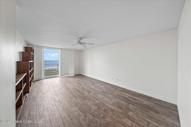 interior space featuring ceiling fan and dark hardwood / wood-style flooring