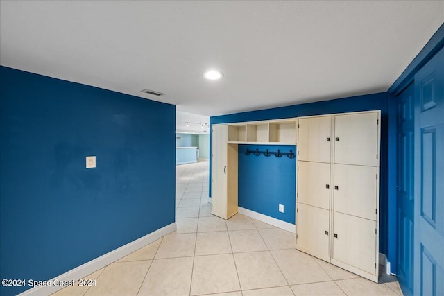 unfurnished bedroom with light tile patterned floors, recessed lighting, a closet, visible vents, and baseboards