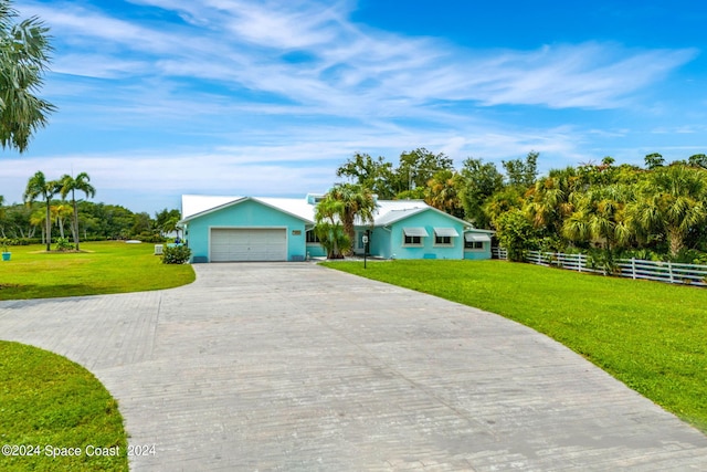 ranch-style house with a front yard and a garage