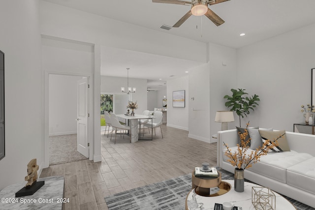 living room featuring ceiling fan with notable chandelier and light carpet