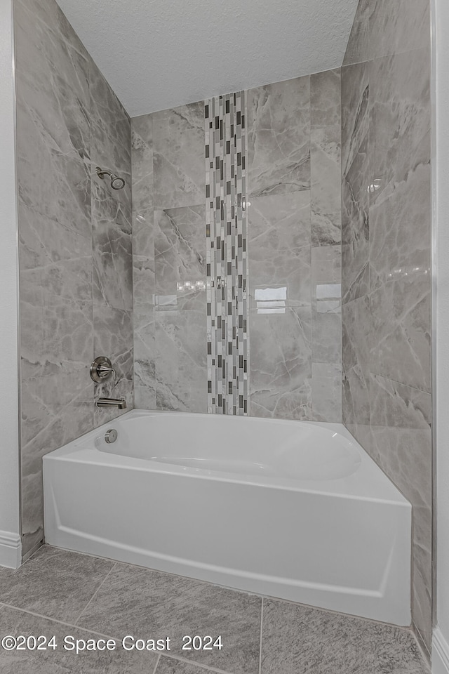 bathroom with a textured ceiling, tile walls, shower with separate bathtub, and tile patterned floors