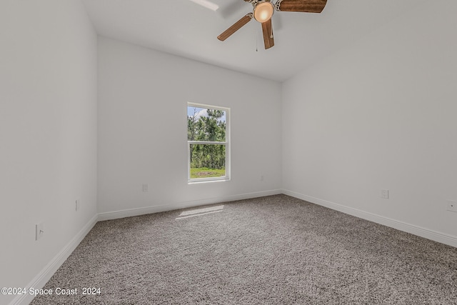 unfurnished room with ceiling fan and carpet