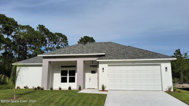 view of front of home featuring a garage and a front yard