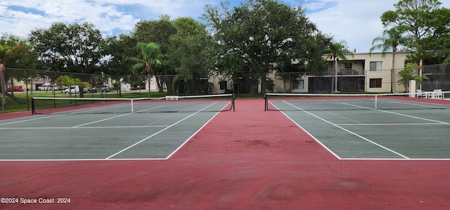 view of tennis court with fence and community basketball court
